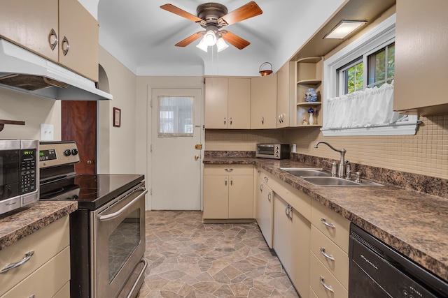 kitchen featuring ceiling fan, sink, cream cabinetry, decorative backsplash, and appliances with stainless steel finishes