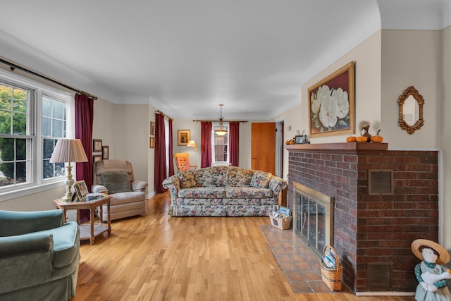 living room with light wood-type flooring and a fireplace