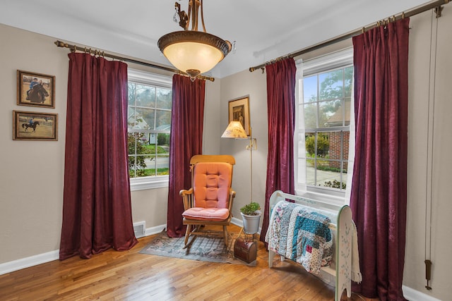 sitting room with hardwood / wood-style floors and a wealth of natural light