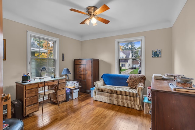 office area with ceiling fan, a healthy amount of sunlight, and light hardwood / wood-style floors