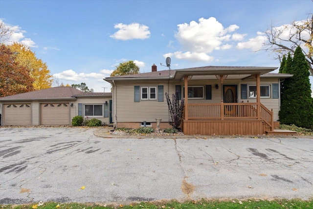 view of front facade featuring covered porch and a garage