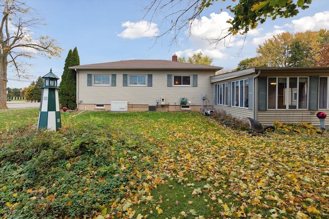 back of house with a yard, central AC, and a sunroom