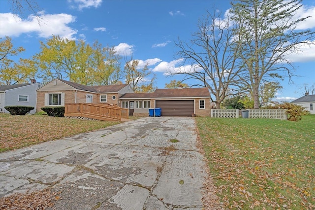 ranch-style house featuring a garage, a front lawn, and a deck