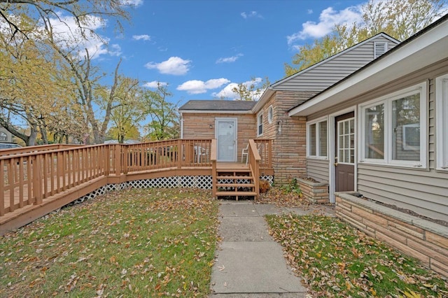 wooden terrace featuring a lawn