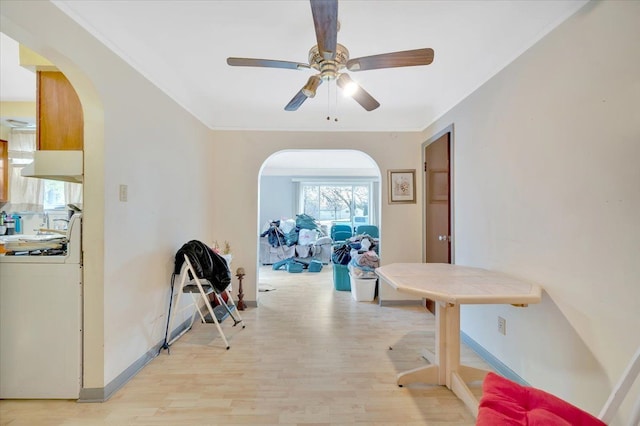 hallway with crown molding and light hardwood / wood-style flooring