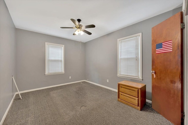 empty room featuring carpet floors and ceiling fan