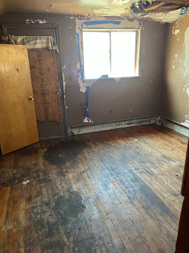 empty room with hardwood / wood-style flooring