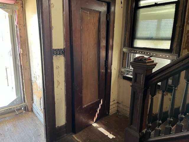 hall with hardwood / wood-style floors