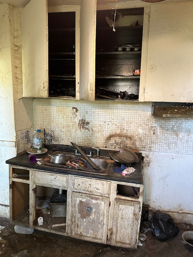 kitchen featuring tasteful backsplash and sink