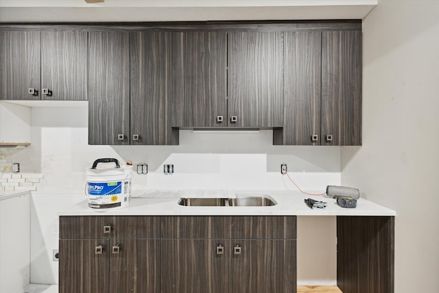 800 NW Douglas St, Grand Rapids, MI 49505 - kitchen featuring dark brown cabinetry, light countertops, modern cabinets, and a sink