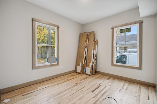 spare room with plenty of natural light and light wood-type flooring