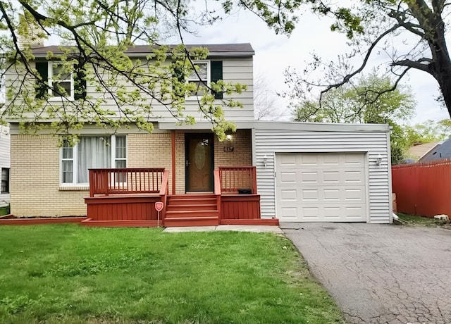 view of front of property with a garage and a front lawn