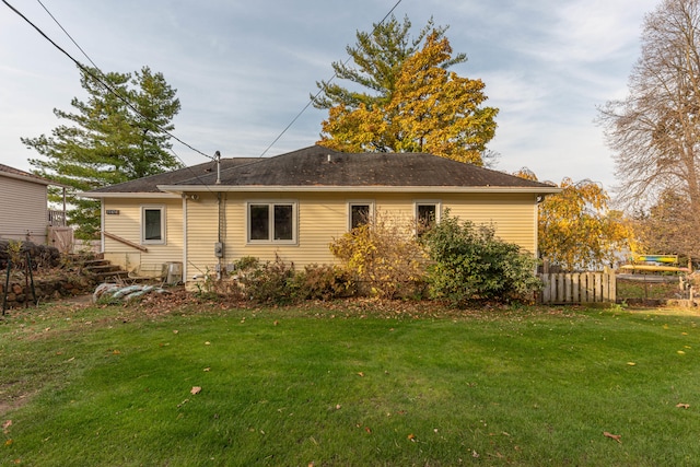 back of house with a lawn