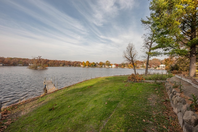 exterior space with a boat dock and a water view