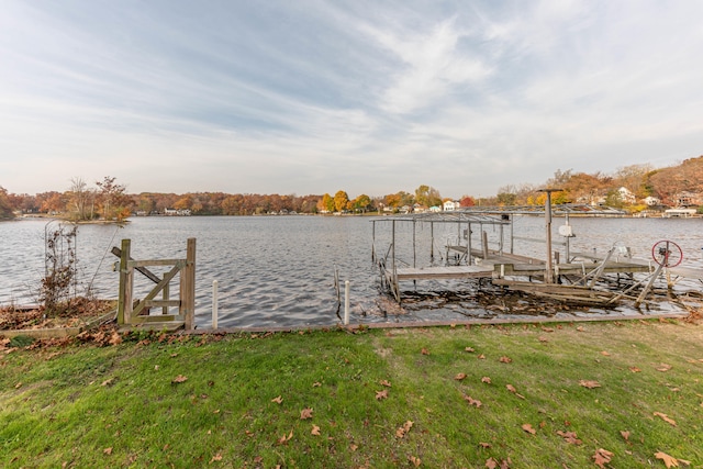 dock area featuring a lawn and a water view