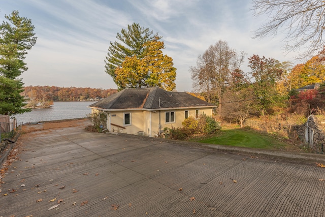 view of side of home with a water view