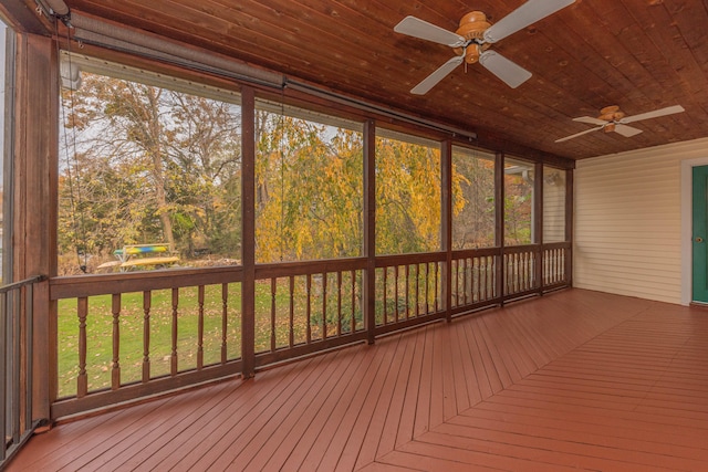 unfurnished sunroom with ceiling fan and wooden ceiling