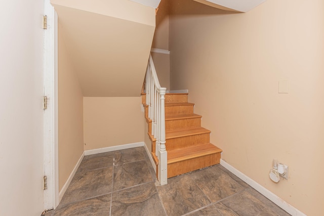 stairway featuring vaulted ceiling