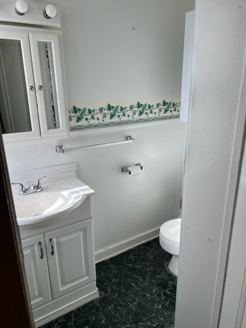 bathroom featuring vanity and toilet