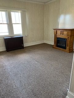 unfurnished living room featuring light carpet