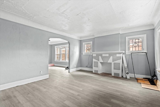 16644 Washburn St, Detroit, MI 48221 - spare room with arched walkways, wood finished floors, plenty of natural light, baseboards, and a textured ceiling
