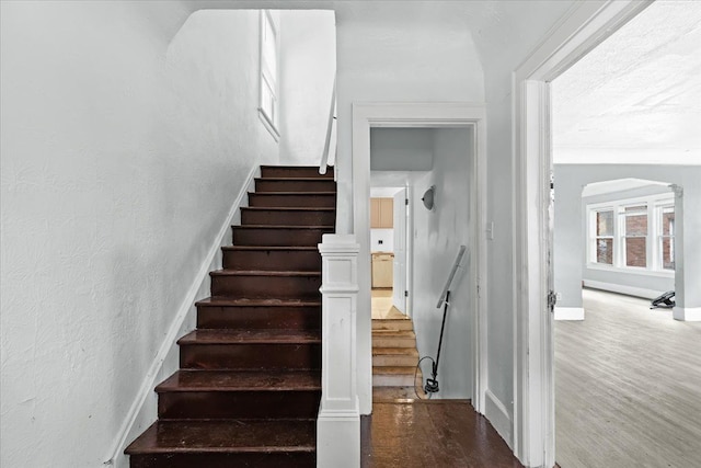16644 Washburn St, Detroit, MI 48221 - staircase featuring wood finished floors, baseboards, and arched walkways