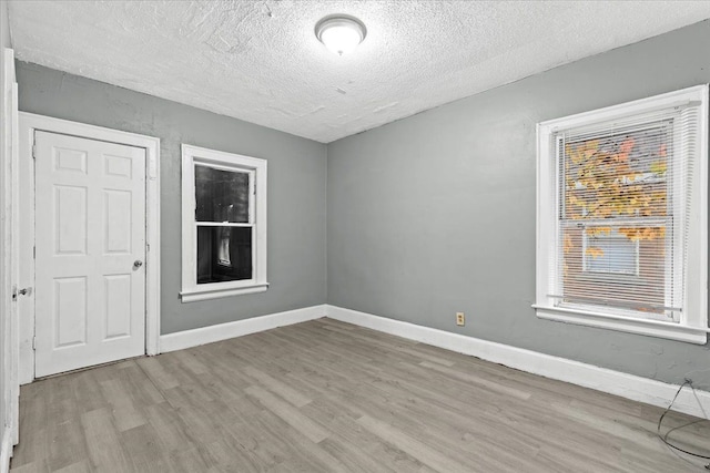 16644 Washburn St, Detroit, MI 48221 - empty room featuring wood finished floors, a textured ceiling, and baseboards