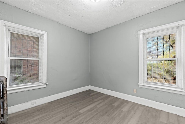16644 Washburn St, Detroit, MI 48221 - empty room featuring wood finished floors, a textured ceiling, and baseboards