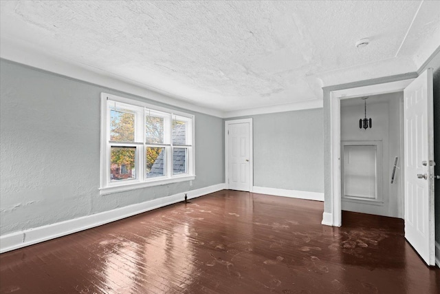 16644 Washburn St, Detroit, MI 48221 - unfurnished room featuring a textured ceiling, baseboards, wood finished floors, and a smoke detector