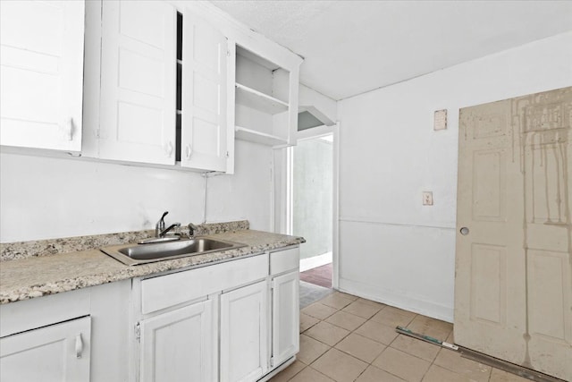 16644 Washburn St, Detroit, MI 48221 - kitchen with a sink, light countertops, white cabinetry, and light tile patterned floors