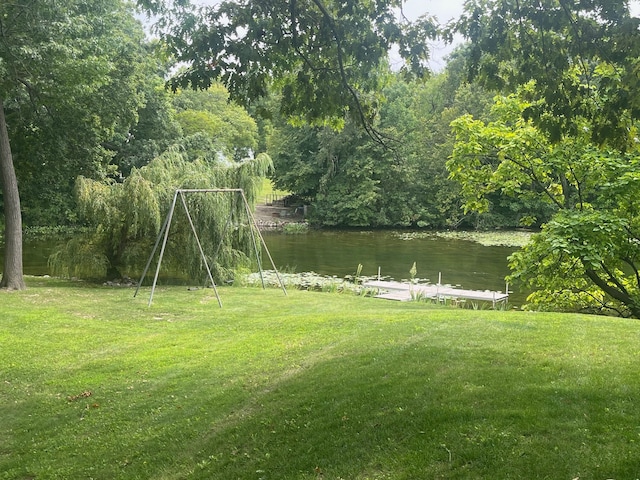 view of yard with a boat dock and a water view