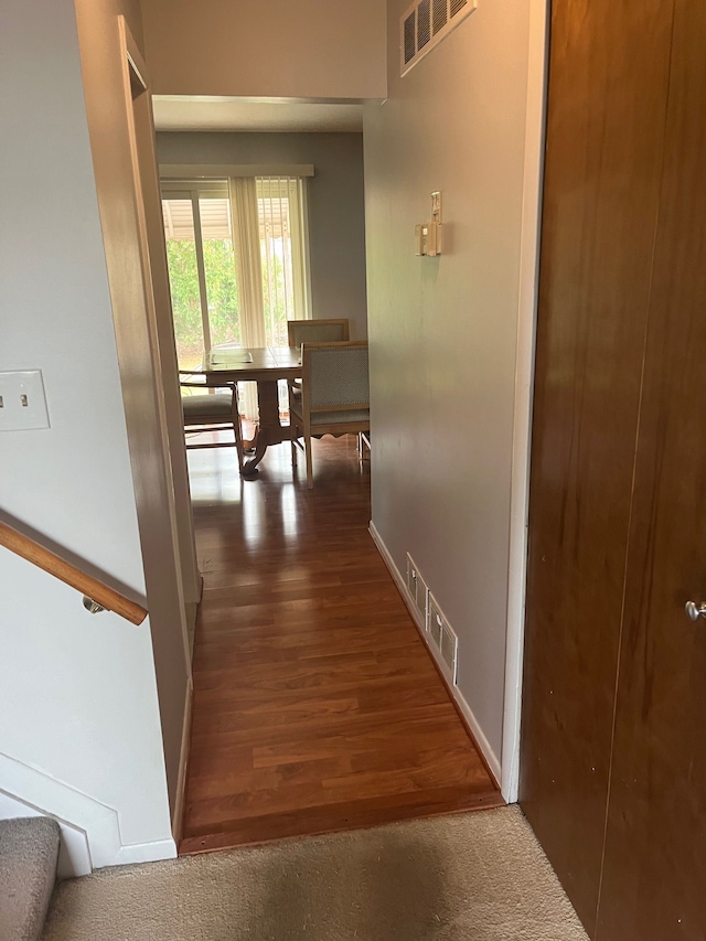 corridor with dark hardwood / wood-style flooring