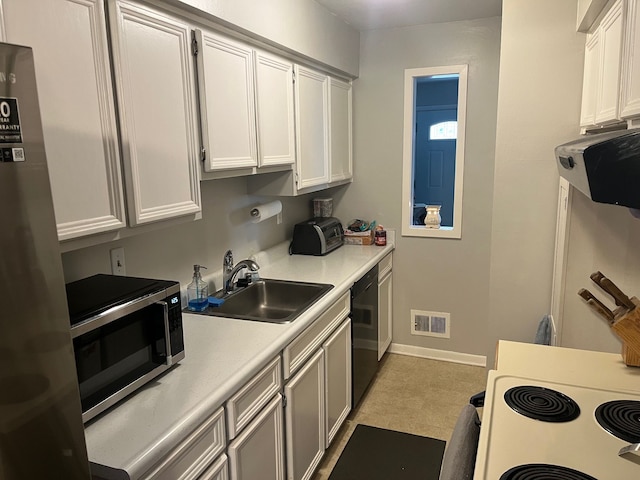 kitchen featuring white cabinets, range hood, sink, and appliances with stainless steel finishes