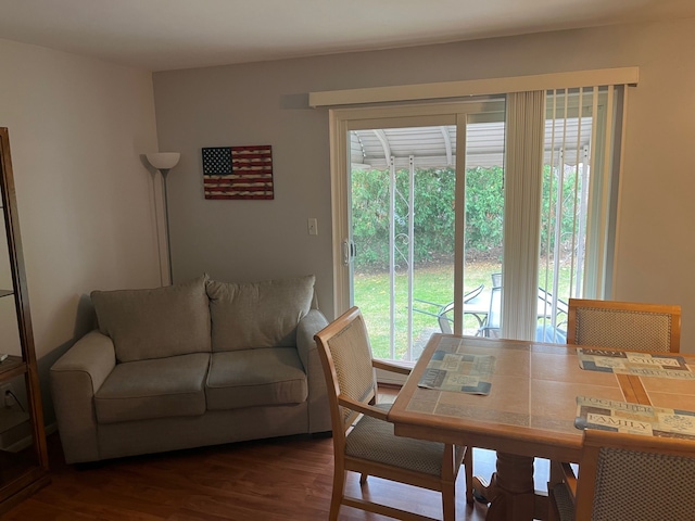 dining area featuring dark wood-type flooring