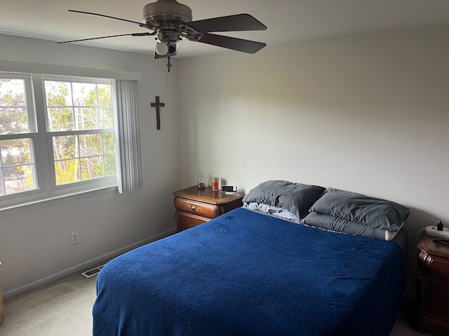 bedroom featuring ceiling fan and carpet