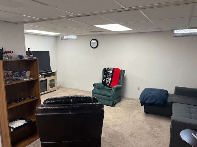 carpeted living room with a paneled ceiling