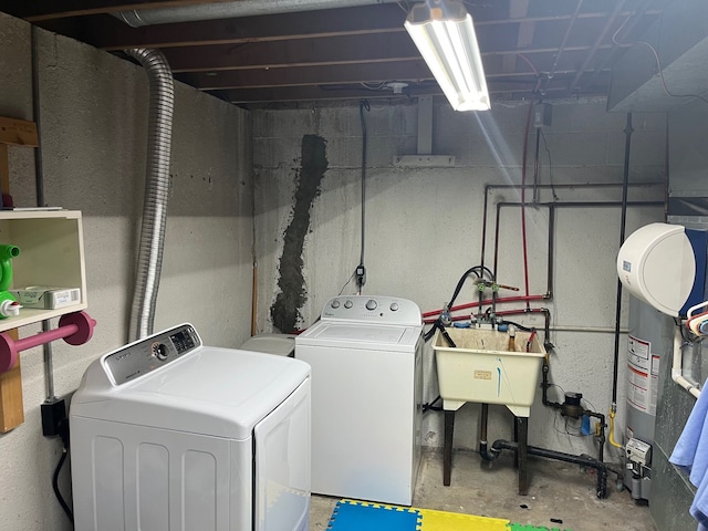 washroom featuring washing machine and dryer, sink, and water heater