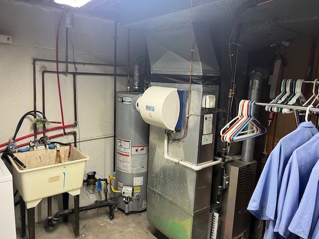 utility room featuring sink and water heater