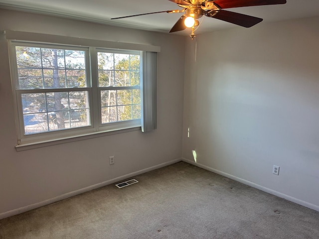 unfurnished room featuring ceiling fan and carpet floors