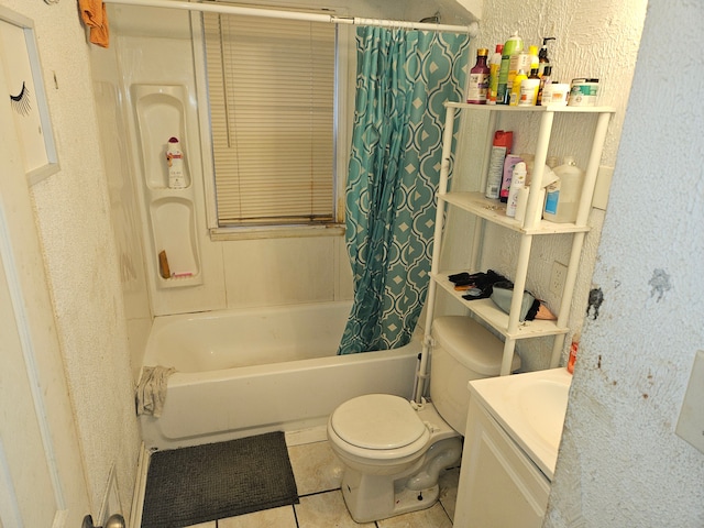 full bathroom featuring tile patterned floors, shower / tub combo with curtain, vanity, and toilet