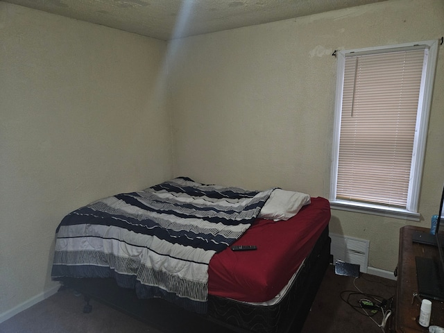 carpeted bedroom with a textured ceiling