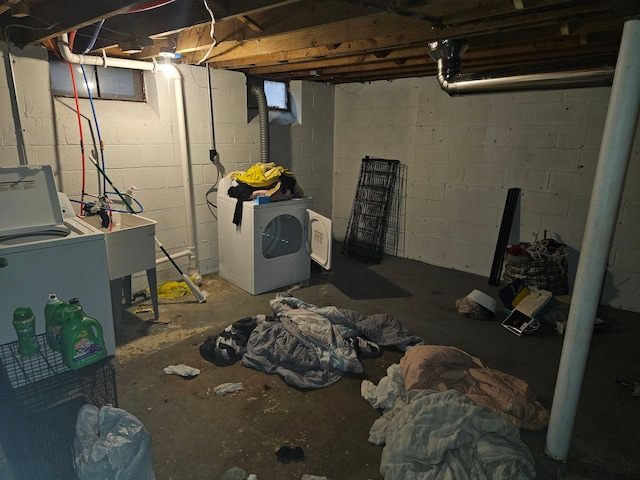 basement featuring washer and clothes dryer and sink