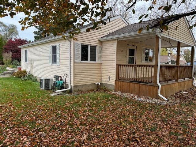 view of home's exterior with central AC and a yard