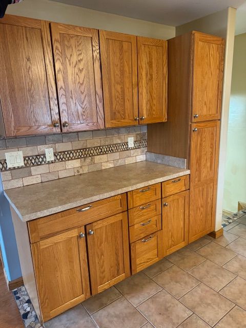 kitchen with light tile patterned floors and backsplash