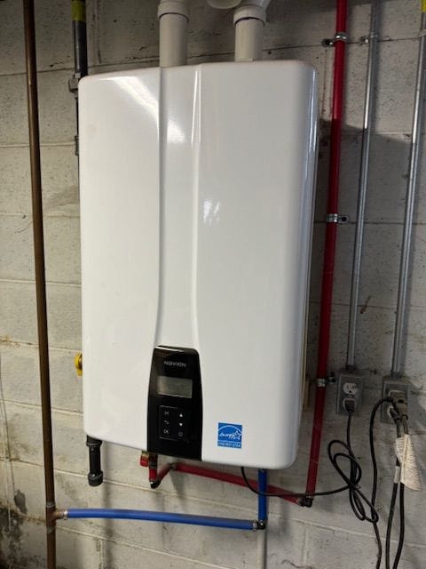 utility room featuring tankless water heater