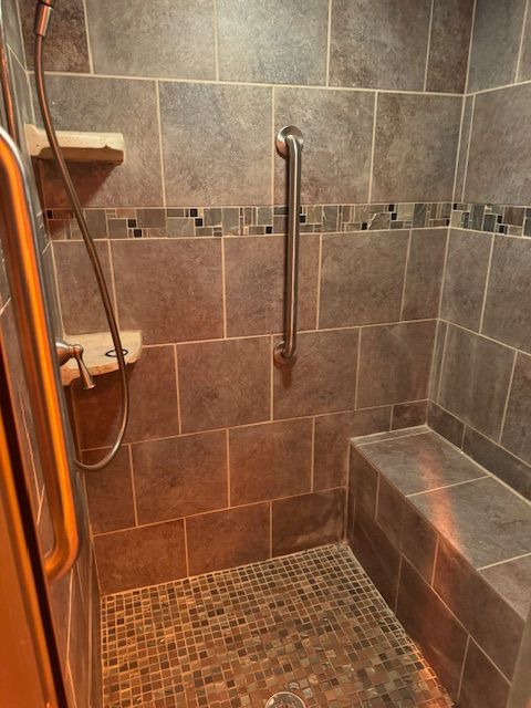 bathroom with a tile shower