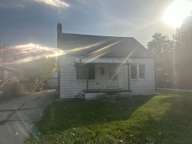 bungalow-style house with a front yard