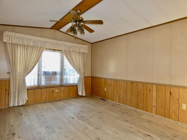 3924 W Jefferson Ave Unit 3924, Trenton, MI 48183 - spare room with a ceiling fan, a wainscoted wall, wood walls, and wood finished floors