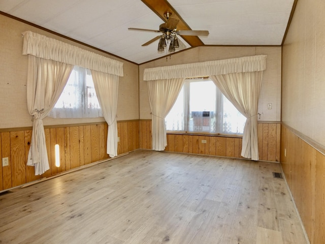 3924 W Jefferson Ave Unit 3924, Trenton, MI 48183 - unfurnished room featuring wooden walls, ceiling fan, wood finished floors, lofted ceiling, and a wainscoted wall