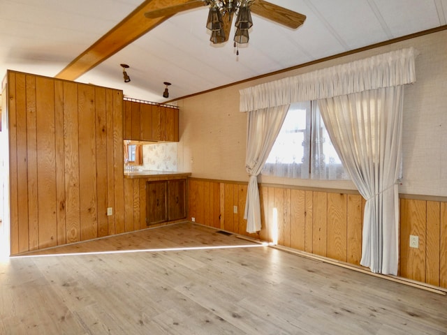 interior space featuring ceiling fan, wooden walls, and wood-type flooring